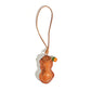 Tan orange peanut shaped leather pendant with cord loop and orange glass bead on a white background