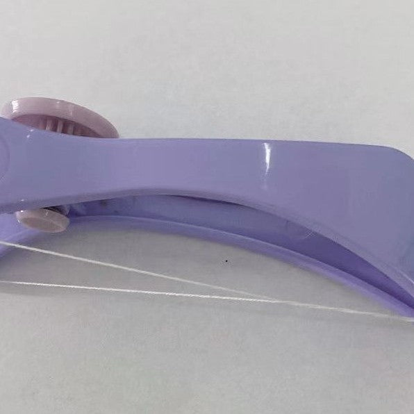 Side view of the curved lilac facial hair remover showing the cotton thread strung under the arc