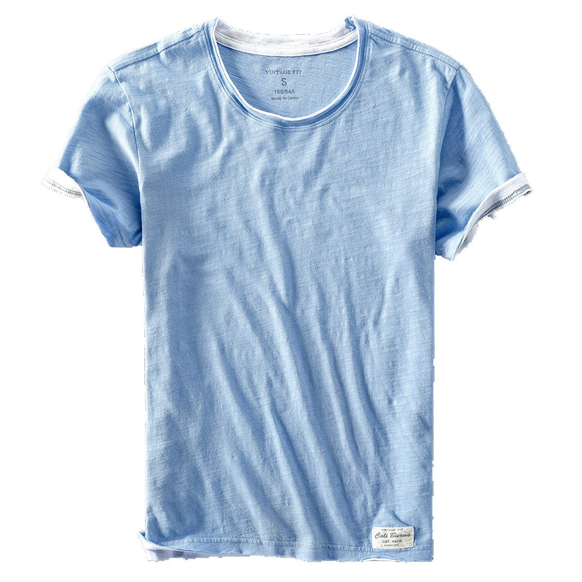 Light blue washed slub cotton tee showing white under trim at the neck and rolled sleeve cuffs