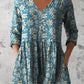 V neck tunic in a digital floral print worn loose with three quarter sleeves
