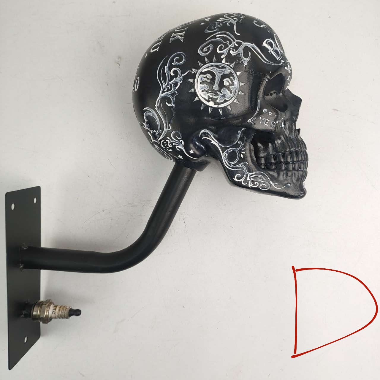 Gilded resin skull finish mounted on a wall as bold punk decor