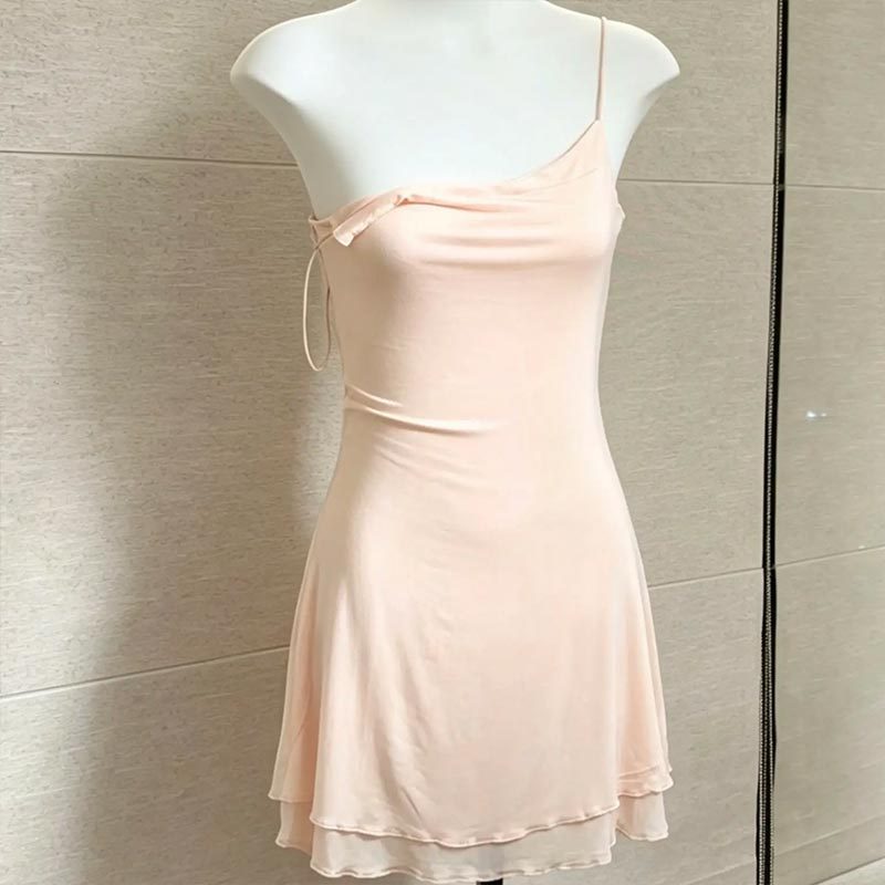 Ballet pink silky slip nightgown on a mannequin showing the short A-line layered hem