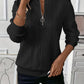 Womens cable knit quarter zip pullover styled as a light autumn layer
