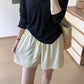 Loose ice silk summer shorts on a woman with a slim tie drawstring at the waist