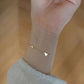Side profile of the heart bracelet showing the rounded heart and slim chain links