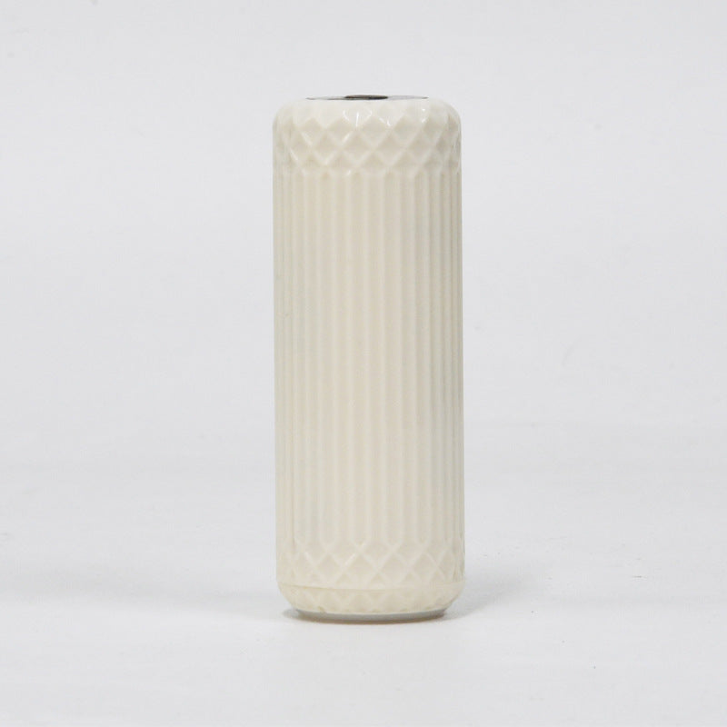 White ribbed handheld vacuum sealer body on a plain background