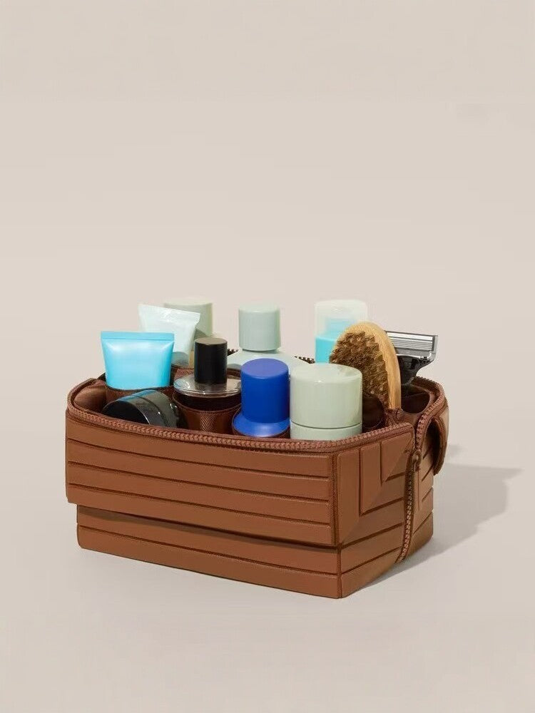 Ribbed stripe makeup and toiletry organizer case with a structured shell and top carry handle