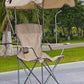 Beige foldable camping chair with a beige canopy and a cup holder on a park path