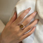 Golden brown tiger eye cabochon bezel set on a wide polished silver band