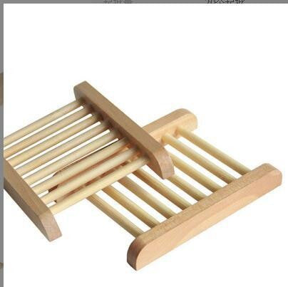 Two ladder style wooden soap trays with round slats and wooden frames on a white background