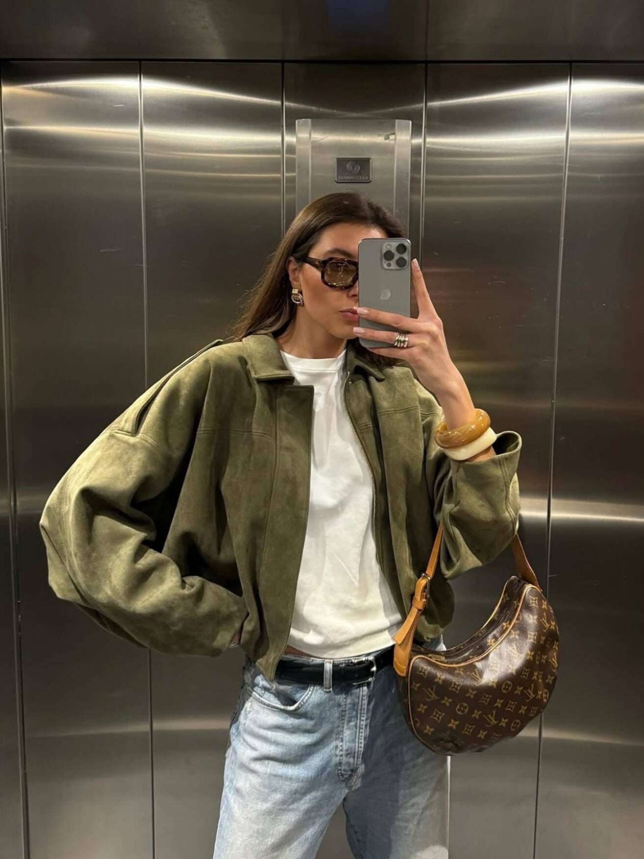 Green women's French retro zip-up jacket worn open as a casual layer