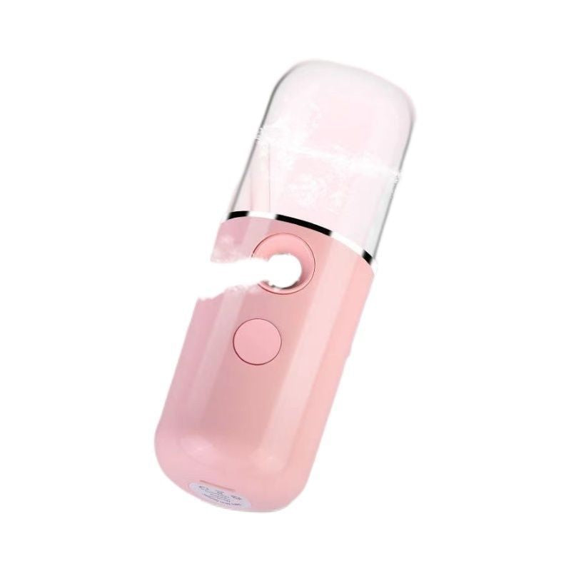 Pink nano facial mister tilted to show the nozzle and base of the device
