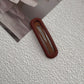 Matte snap hair clip in a muted shade