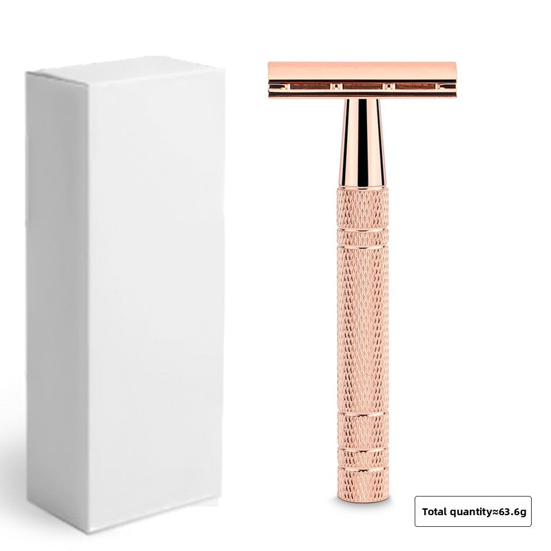Rose gold double edge safety razor standing next to a plain white retail box