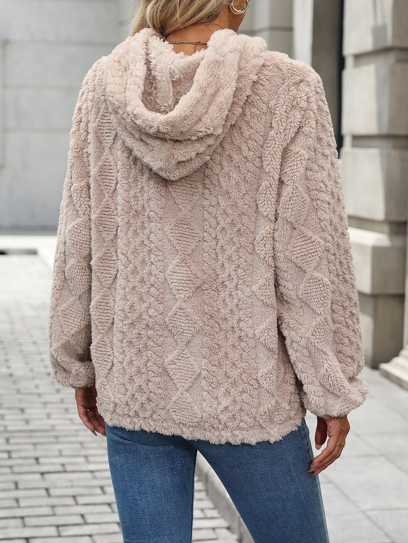 Plush jacquard hooded sweatshirt worn as a relaxed cool-weather layer
