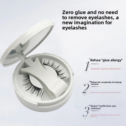 Magnetic false eyelashes in an open round white compact with a mirror lid