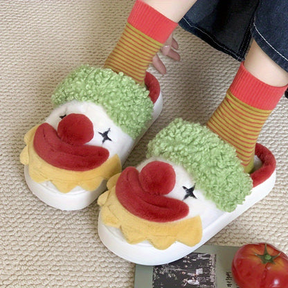 Pair of white plush slippers with green curly fur strap, red pom nose and yellow ruffle collar worn with striped socks