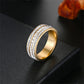 Gold tone three row cubic zirconia band ring on a black surface, size No. 5 option