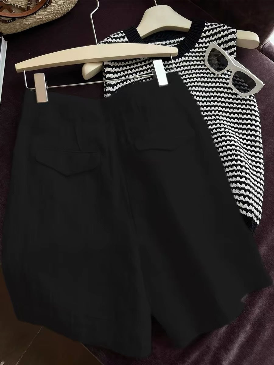 Black linen summer shorts styled with black and white knit top and shades