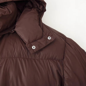 Close up of the brown puffer collar showing metal snap studs that attach the hood