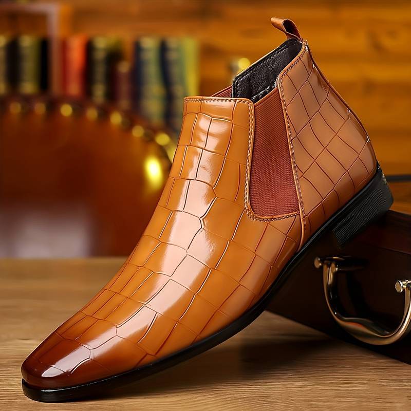 Plaid tan variant, size 40: tan plaid grid ankle boot with an elastic side panel on a wooden case