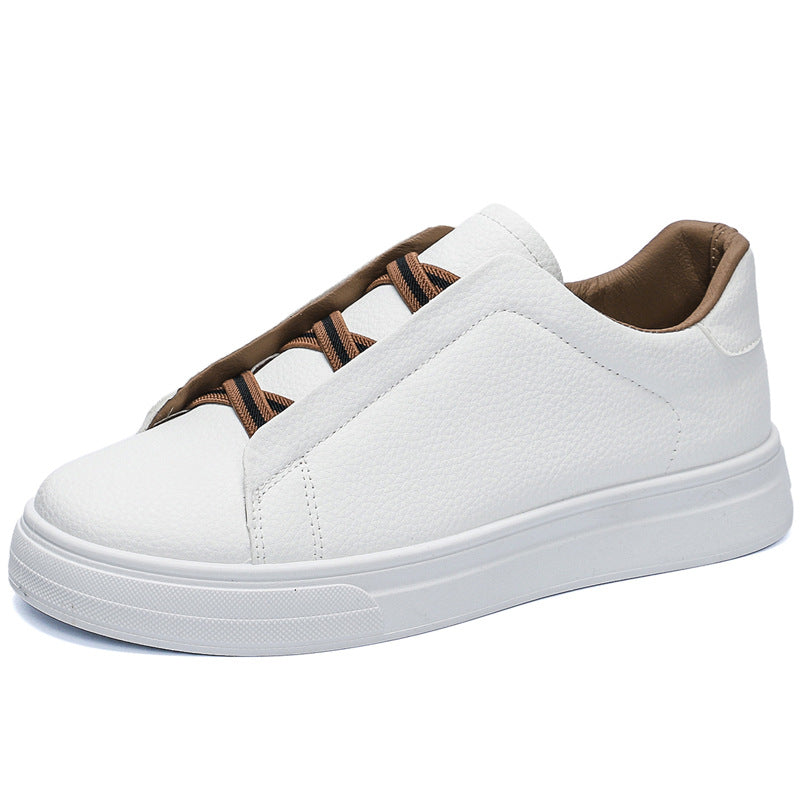 White slip-on low-top sneaker with tan and black elastic cross straps on a white background