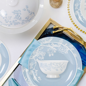 Plum blossom porcelain bowls and plates in a table setting