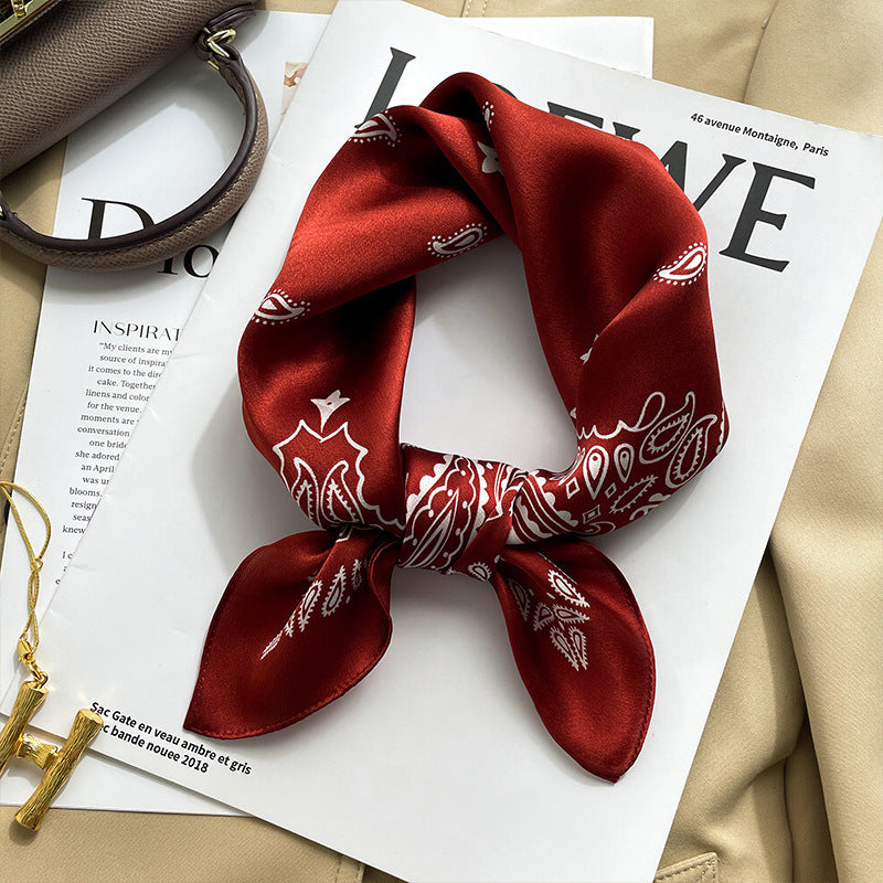 Red folk floral printed square scarf with a satin sheen and hemmed edges, shown displayed and knotted