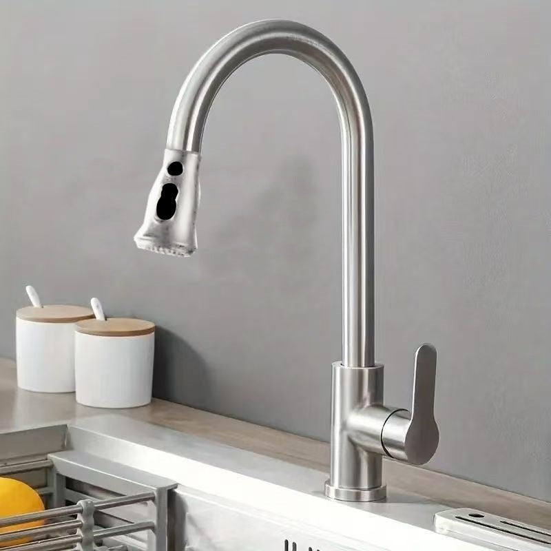 Brushed steel pull out faucet on a sink deck, twin buttons on the spray head clearly visible