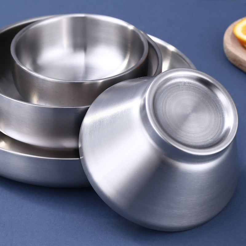 Stacked double wall stainless steel bowls and plate in a brushed silver finish