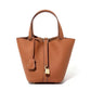 Leather bucket tote bag worn in an everyday outdoor scene