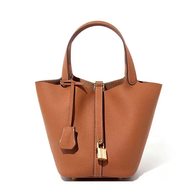 Leather bucket tote bag worn in an everyday outdoor scene
