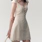 Side profile of the cream white lace patchwork summer dress showing the skirt drape and fit