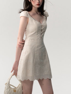 Side profile of the cream white lace patchwork summer dress showing the skirt drape and fit