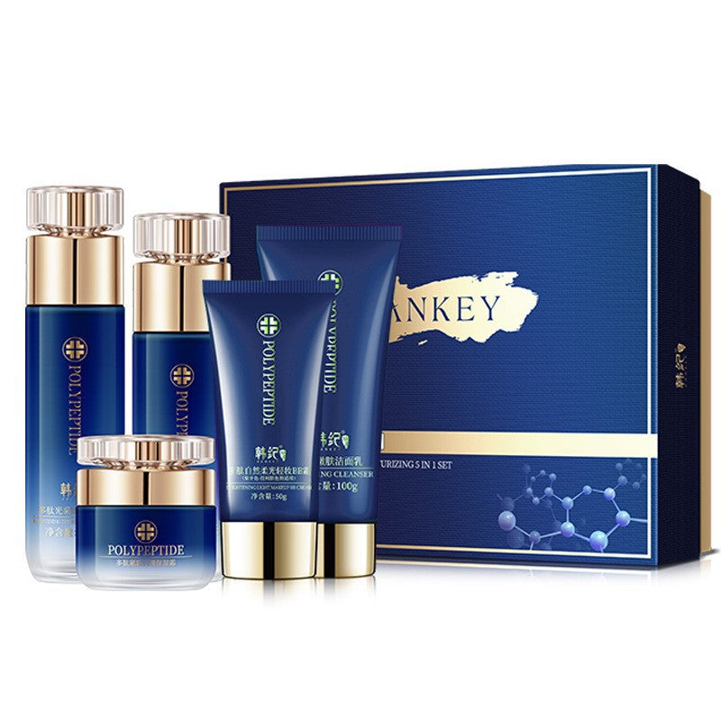 Hankey Polypeptide set of two bottles, a cleanser tube and a cream jar in front of a blue gift box on white
