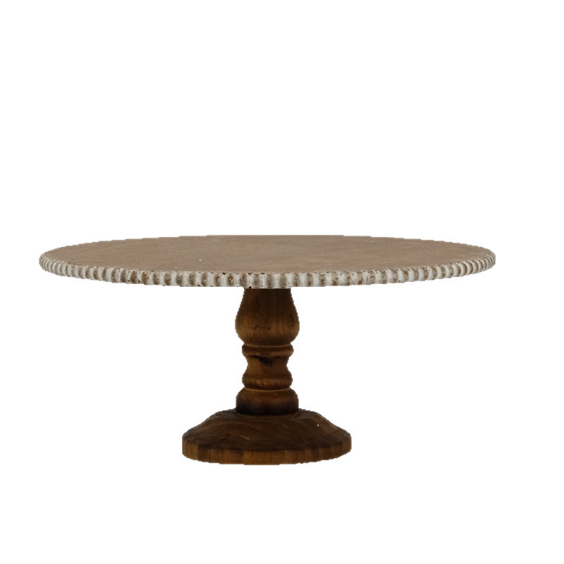 French vintage wooden pedestal cake stand with a distressed cream beaded rim, side view