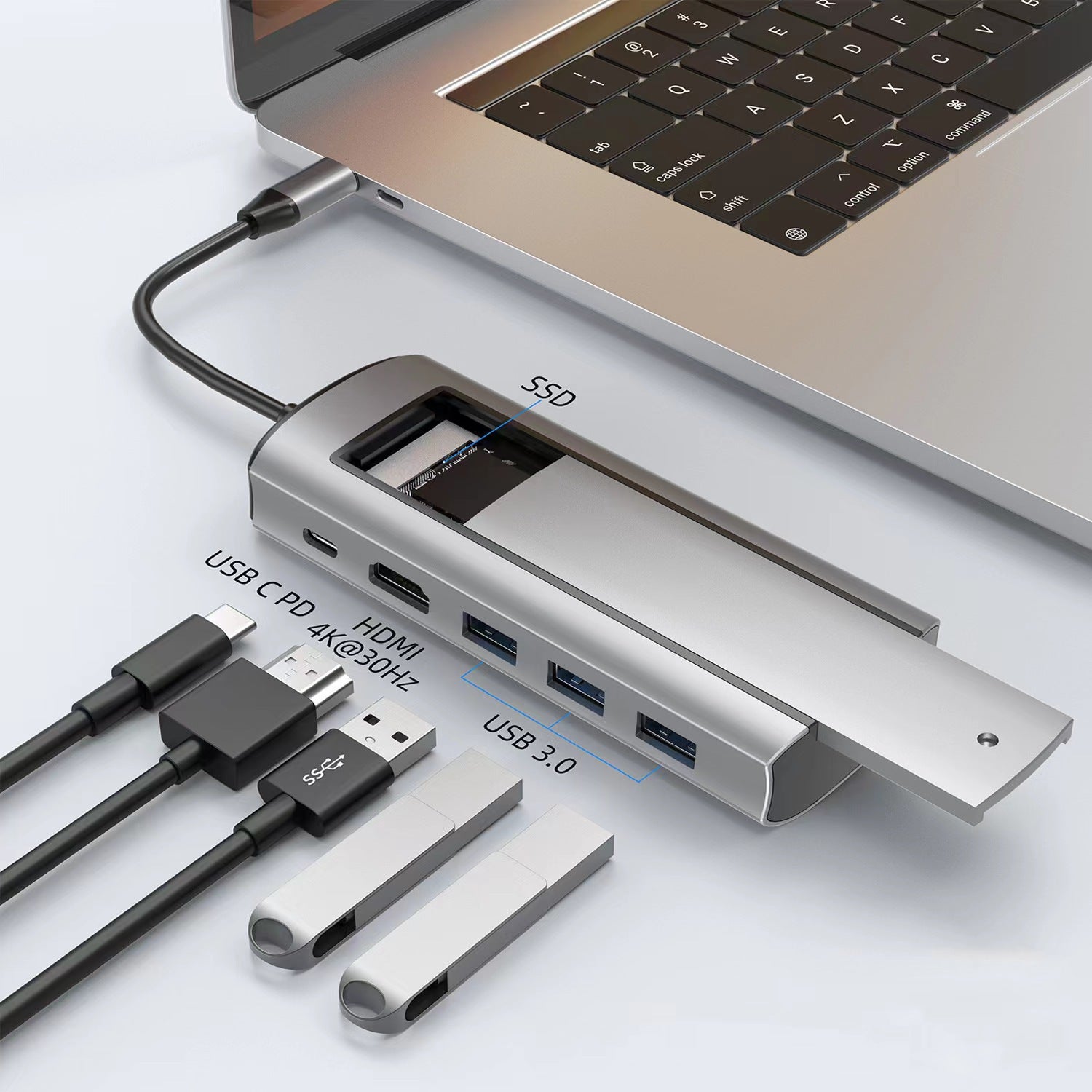 Silver USB-C docking station plugged into a laptop with labeled HDMI and three USB 3.0 ports