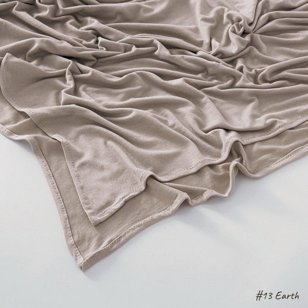Close view of the plain knit modal cotton scarf showing its matte natural texture and soft drape