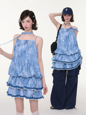 Front view of blue and white plaid pinafore with lace trim at the hem