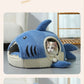 Blue shark nest pet bed with cream ribbed base and a cat looking out of the side opening