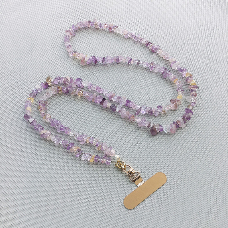 Macro detail of natural amethyst and citrine stone beads on the lanyard cord