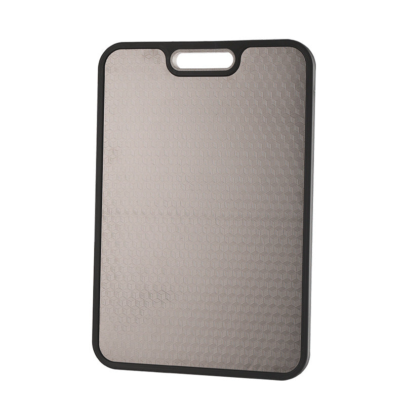 Double-sided titanium and wheat-straw cutting board resting flat on a worktop