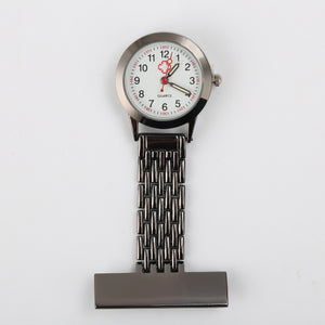 Nurse fob watch with a round white quartz dial and a metal link band ending in a bar brooch back