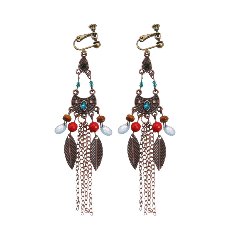 Handmade bohemian clip-on earrings with tassel and bead drop detail, zinc alloy frame, studio shot on white background