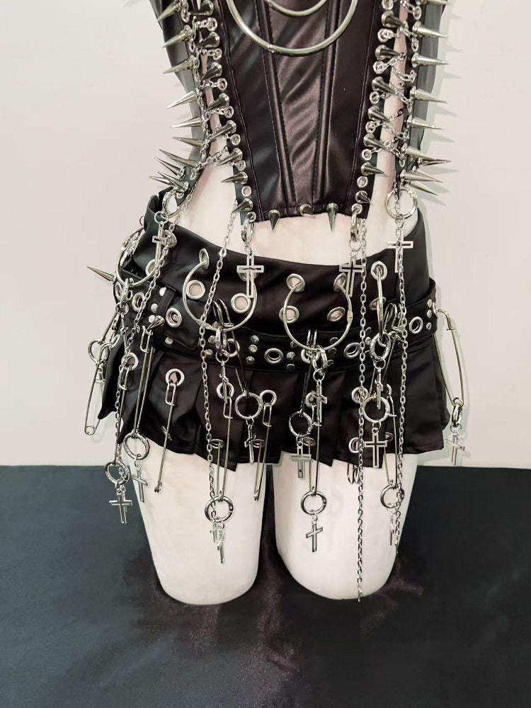 Chained punk mini skirt detail showing eyelets, silver rings and dangling cross pendants