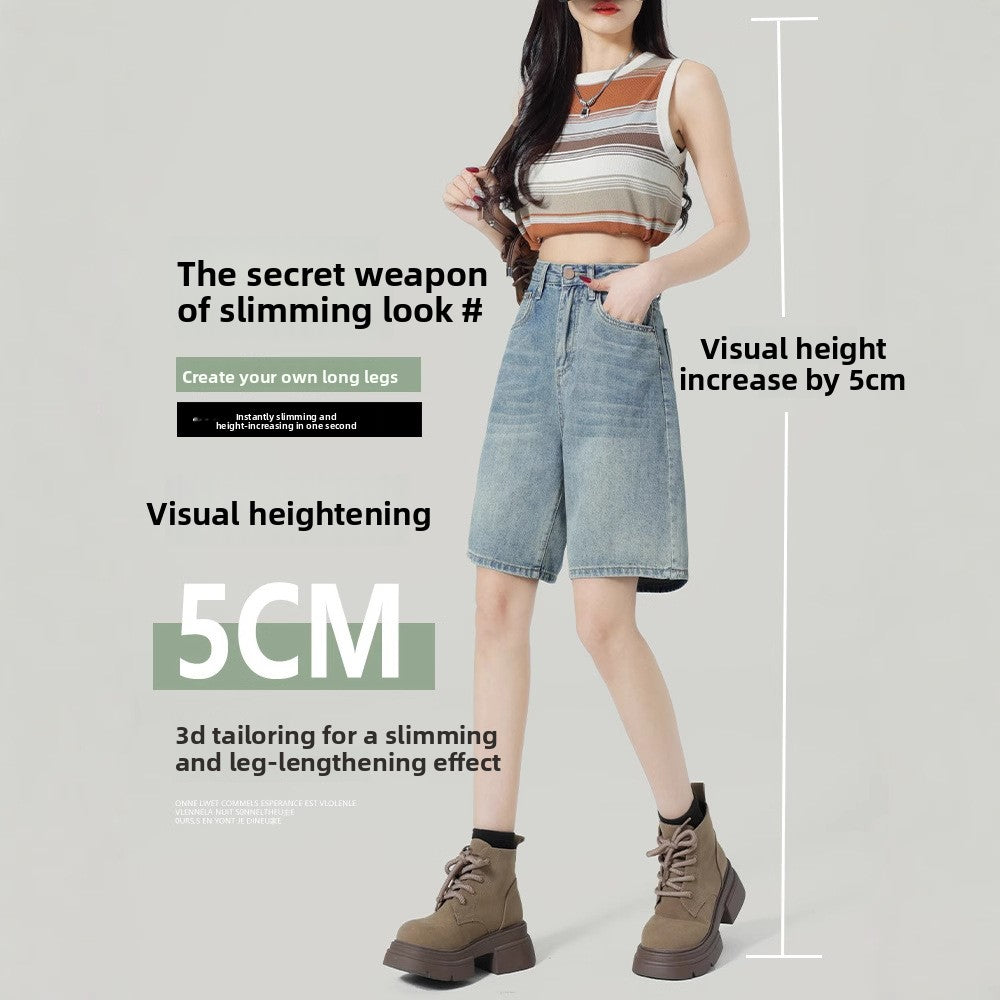 Front view of high-waisted faded blue denim shorts styled with a striped knit top