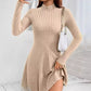 Beige ribbed knit mock neck long sleeve fit and flare mini dress worn with a white chain shoulder bag