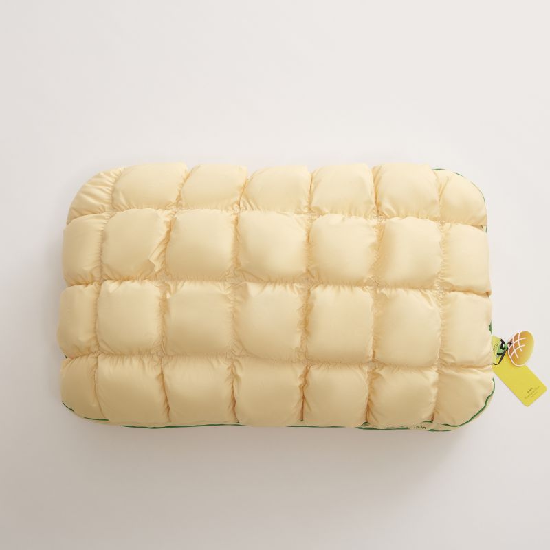 Pale yellow slow rebound bed pillow seen from above, box quilted