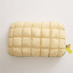 Pale yellow slow rebound bed pillow seen from above, box quilted