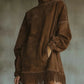 Back view of oversized vegan suede mock neck dress with fringe hem detail